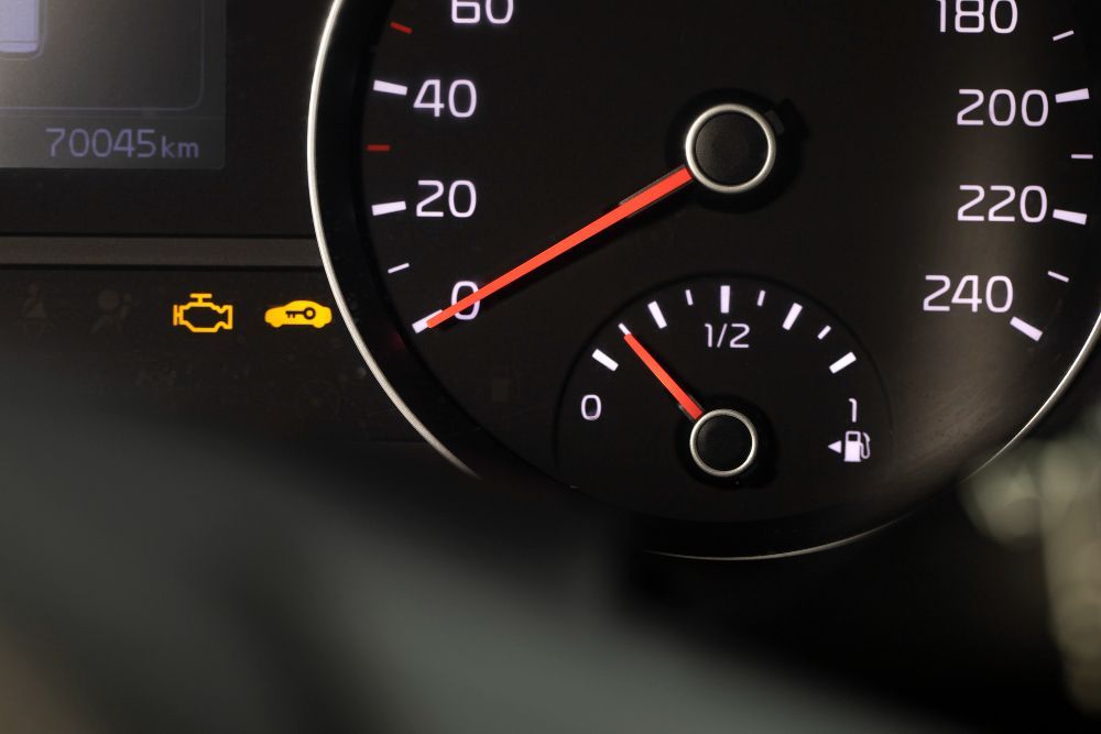 A close up of a car 's speedometer with the number 240 on it