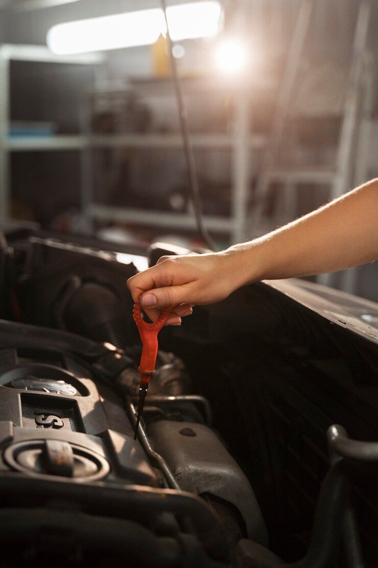 A person is pouring oil into a car engine.