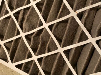 Dirty air filter with white grid.