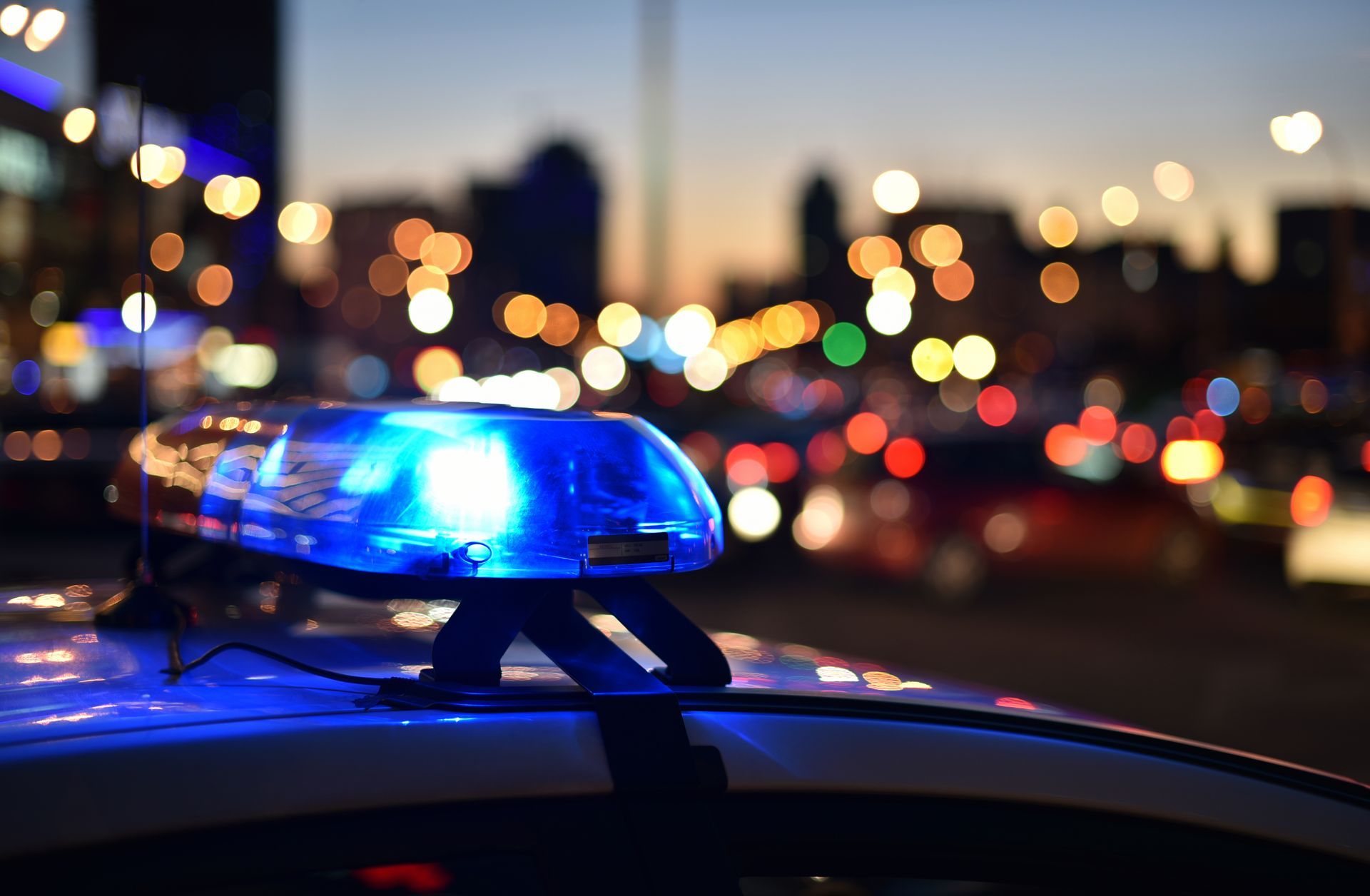 A police car with a blue light on top of it.