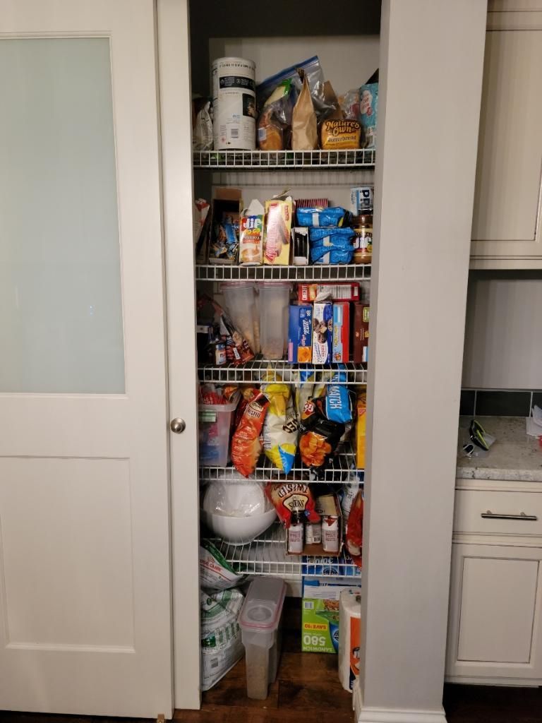 A pantry filled with lots of food in a kitchen.