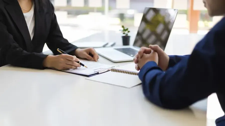 Recruiter interviewing a job candidate in a professional setting, illustrating effective hiring