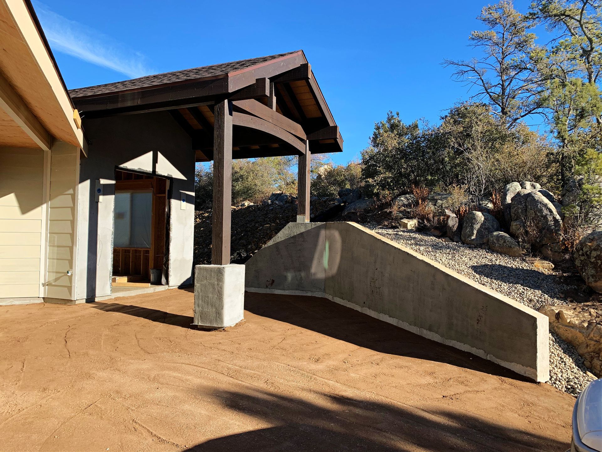 Unfinished front door of the Perfect Place custom home in Prescott, AZ, during retaining wall construction, showcasing progress on the custom build.