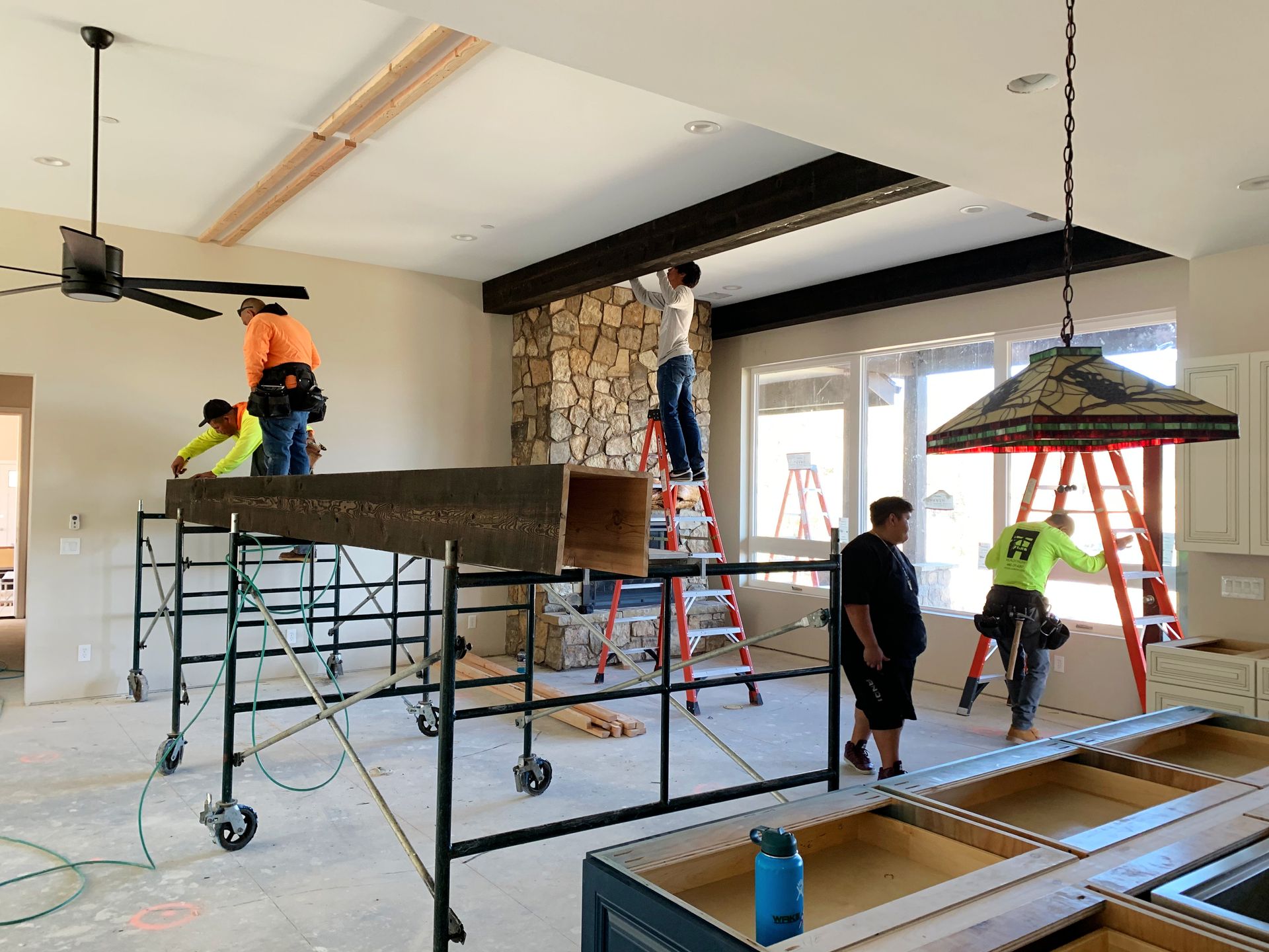 Construction team working in the great room of the Perfect Place custom home in Prescott, AZ, during the building process, highlighting collaboration and craftsmanship.