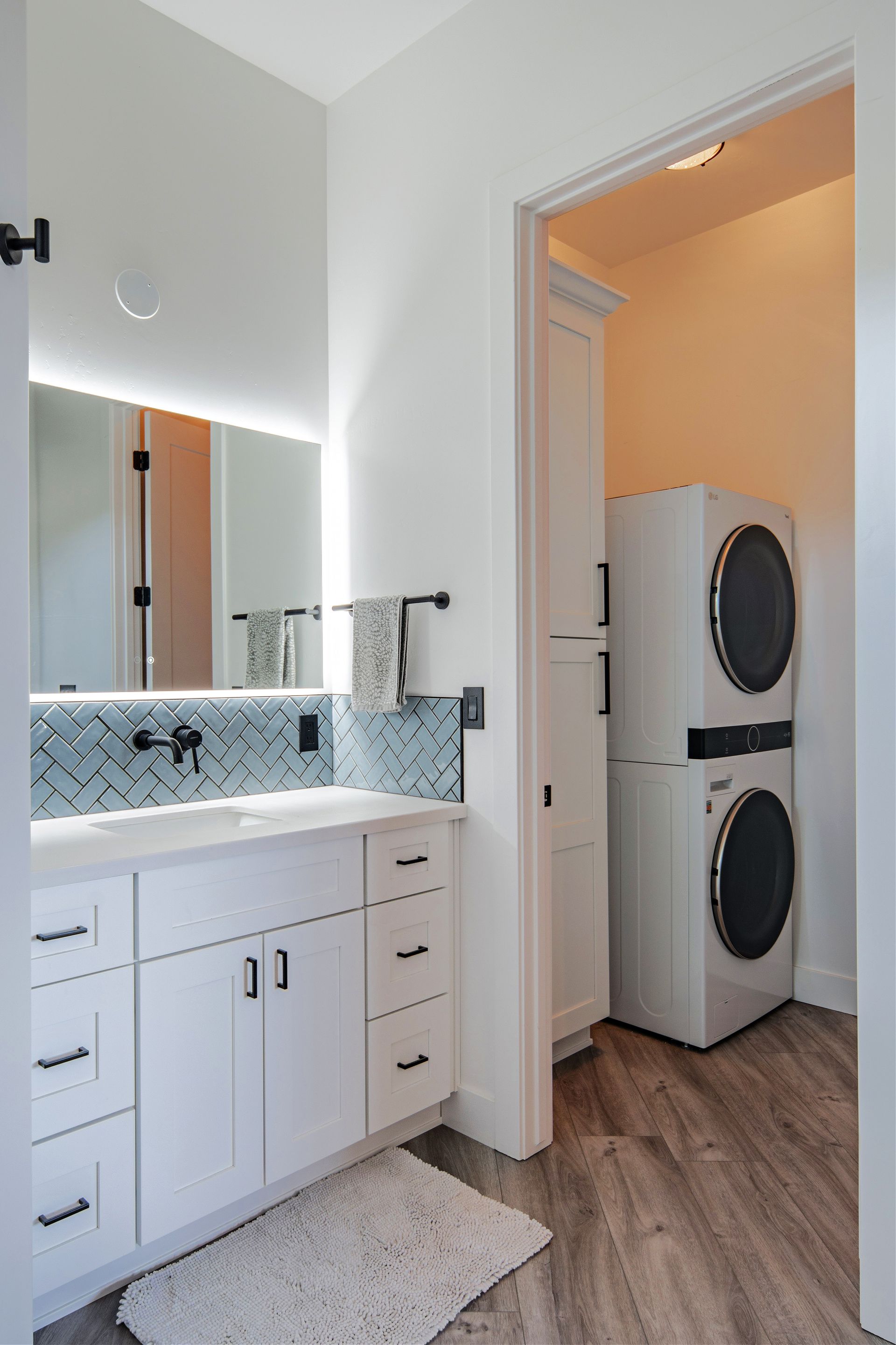 Laundry area in a custom cliffside home on Jordin Drive in Prescott, AZ, showcasing energy-efficient washer and dryer with sleek cabinetry and modern design.