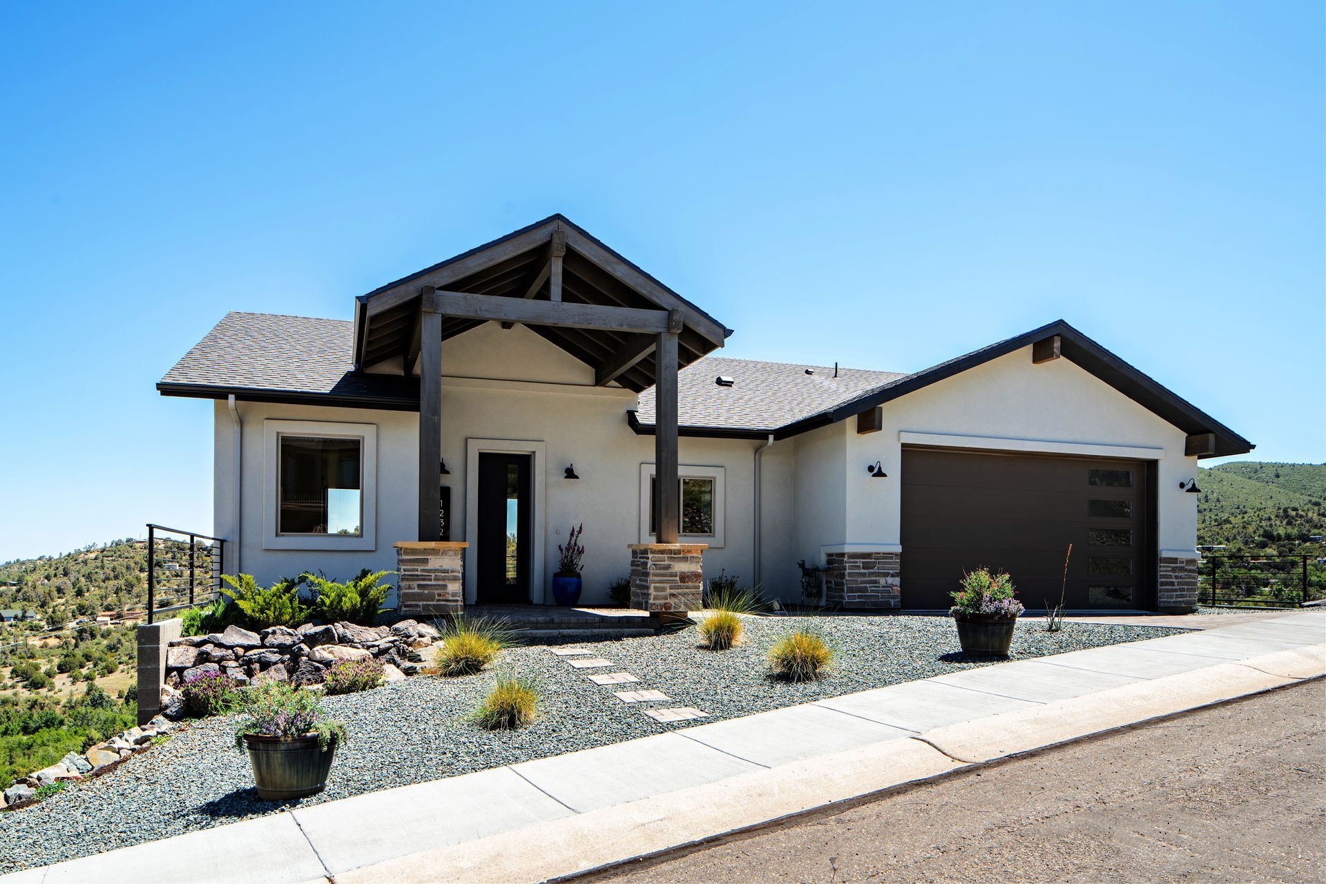 Daytime view of a custom cliffside home on Jordin Drive in Prescott, AZ, showcasing its modern design and seamless integration with the surrounding terrain.