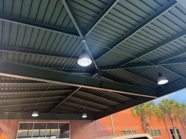 A person is installing an electrical outlet in a wooden wall.