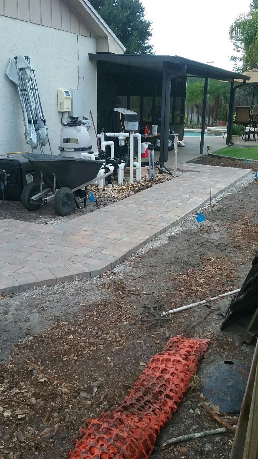 A wheelbarrow is parked in front of a house.