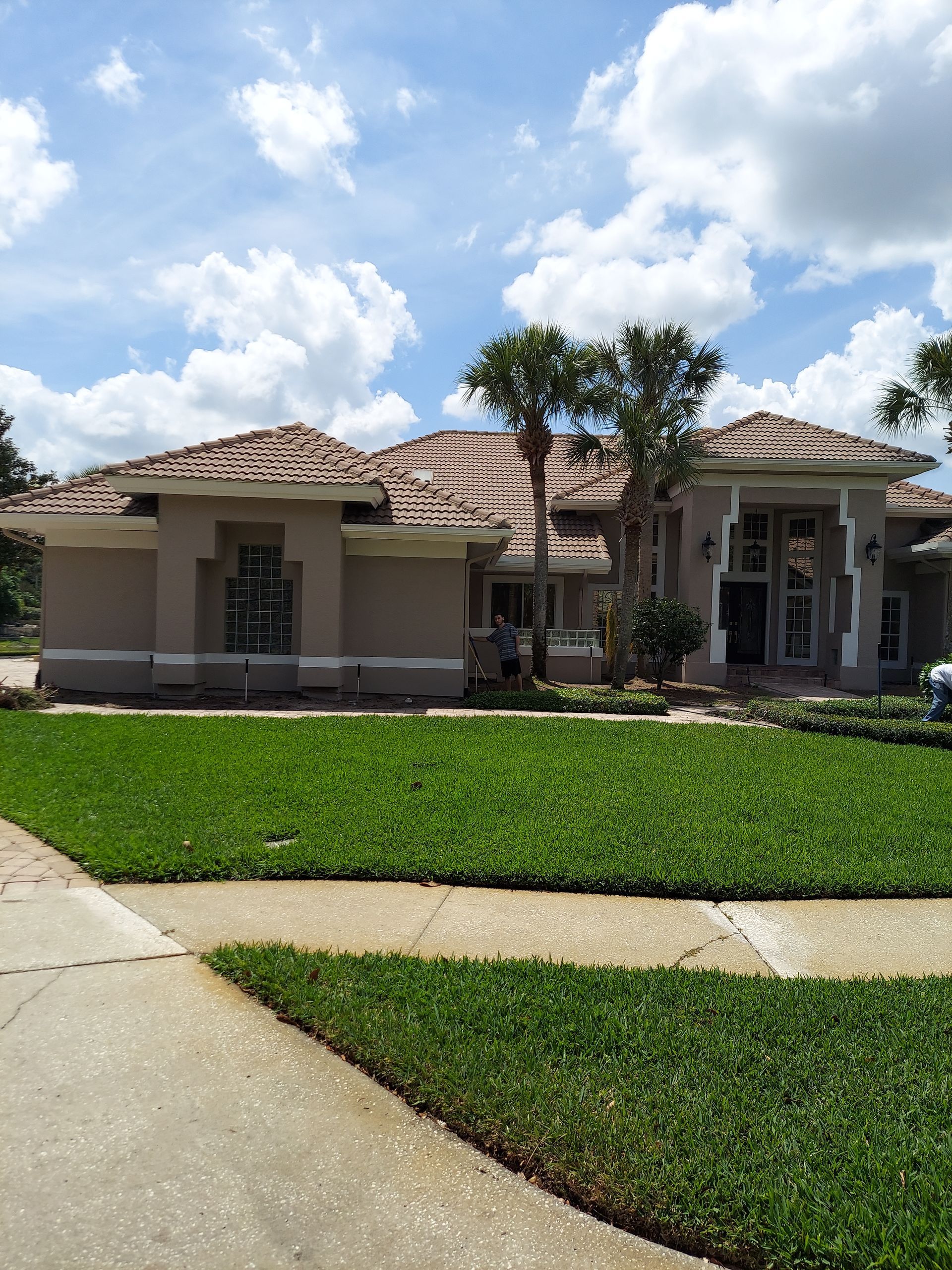 A large house with a lush green lawn in front of it