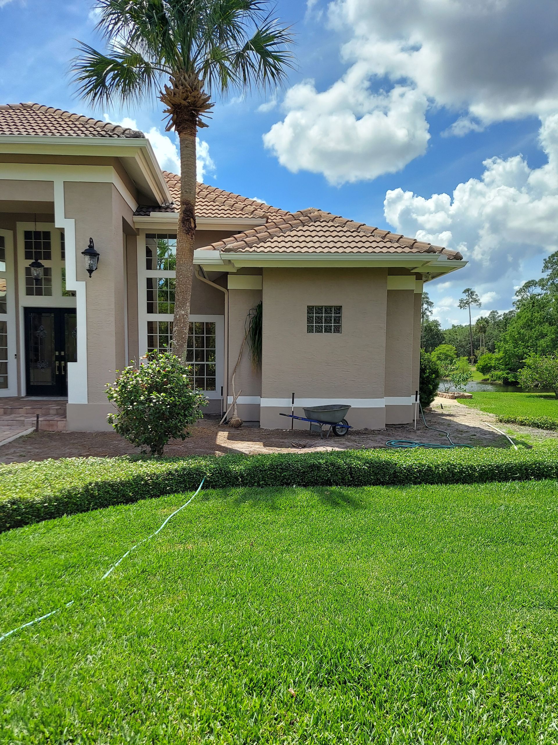 A large house with a lush green lawn in front of it.