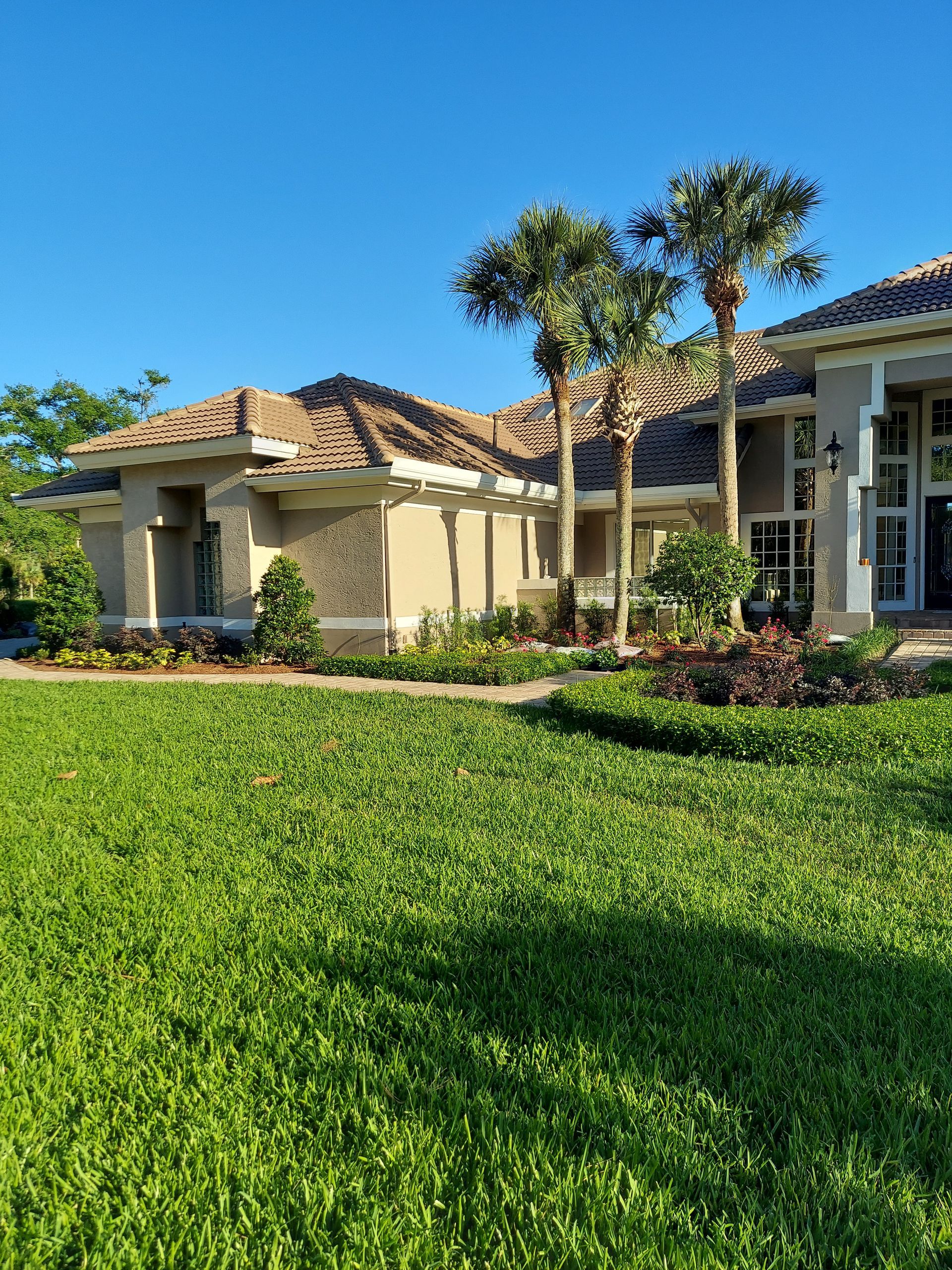A large house with a lush green lawn in front of it