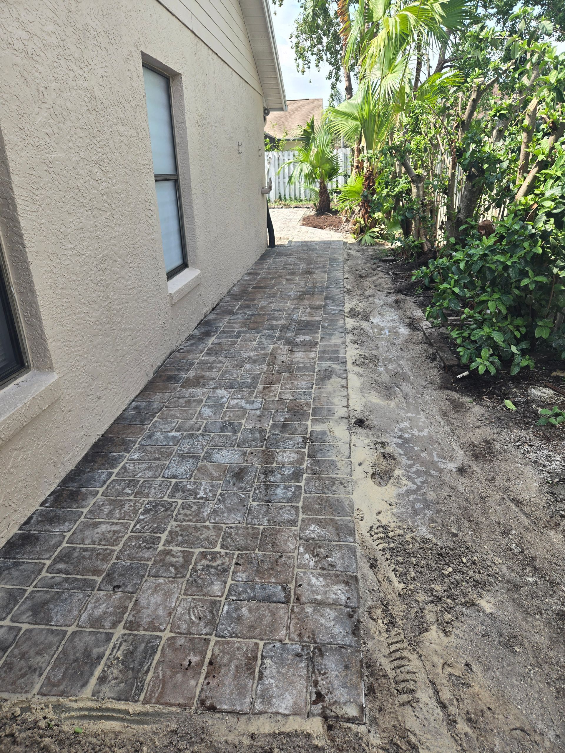 A sidewalk is being built in front of a house.