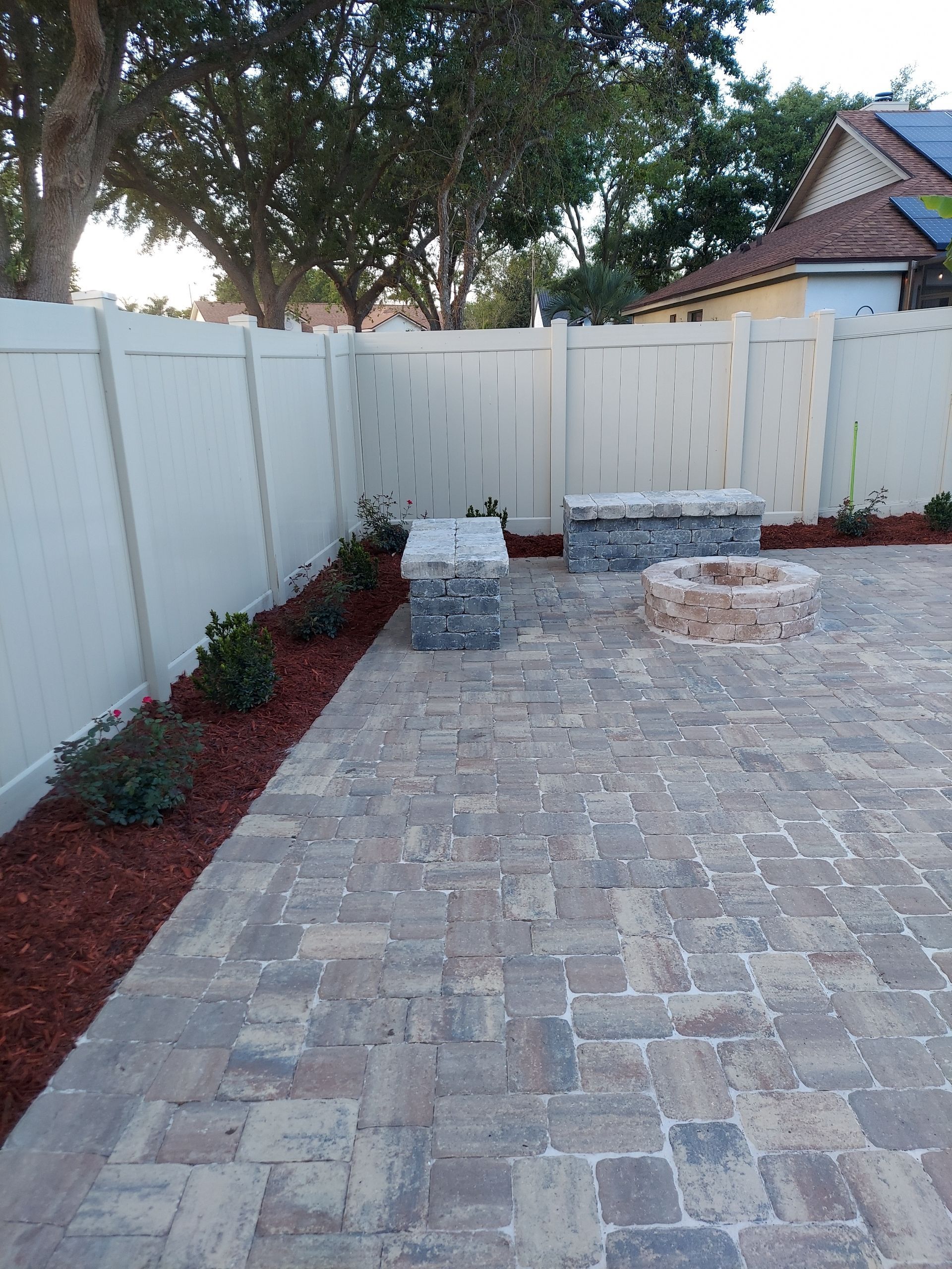 There is a fire pit in the middle of the patio.