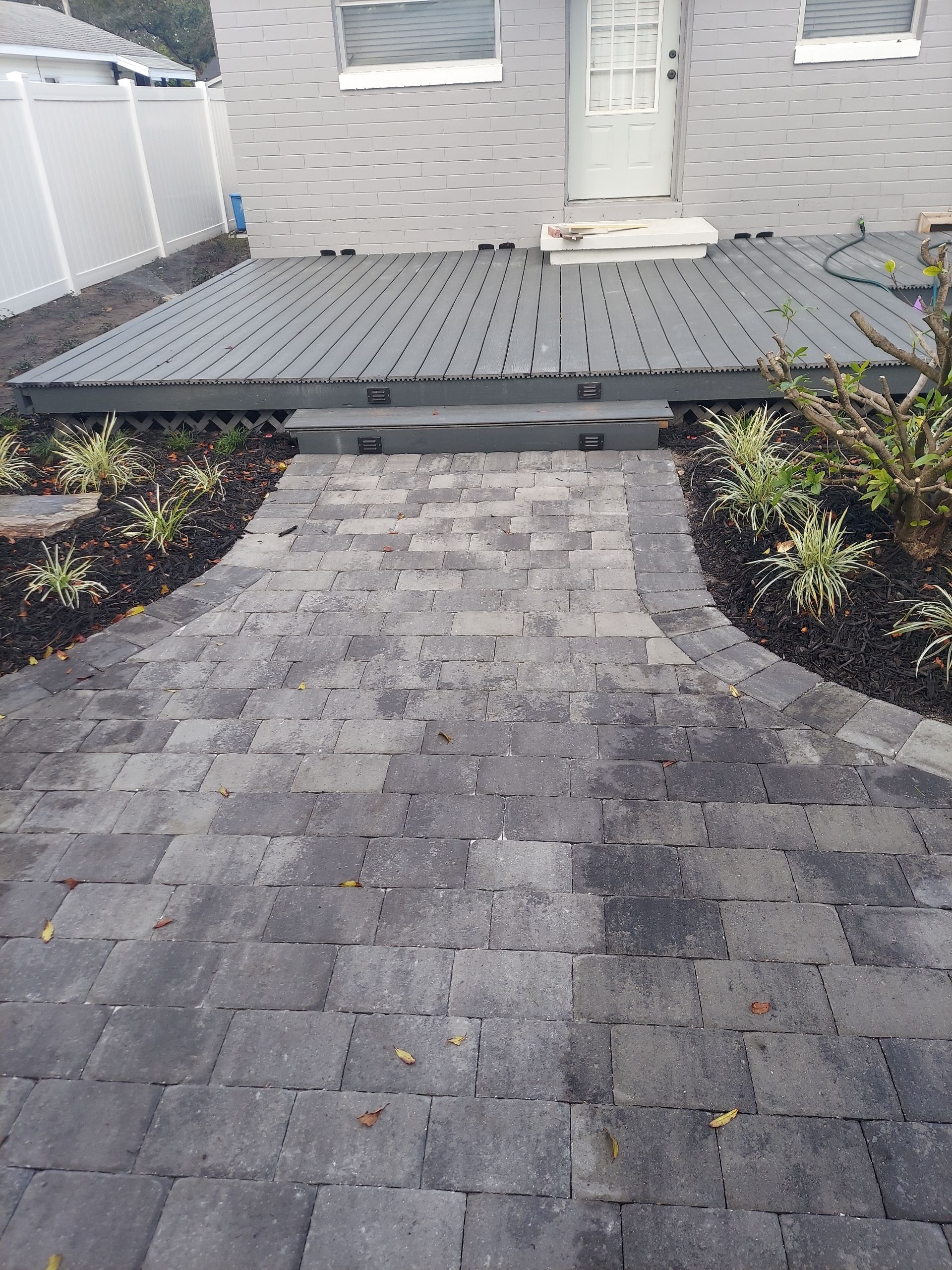 A person is cutting a tree stump with a machine.