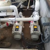 A couple of pumps are sitting next to each other in a room.