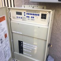 A white box with a digital display on top of it.