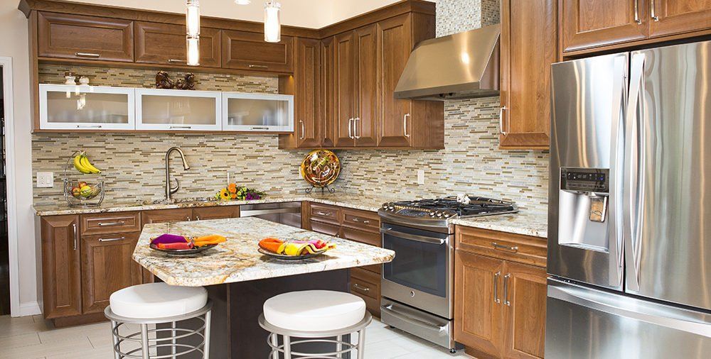 A kitchen with stainless steel appliances and wooden cabinets.