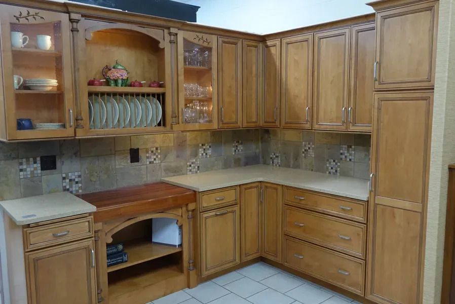 A kitchen with wooden cabinets and granite counter tops