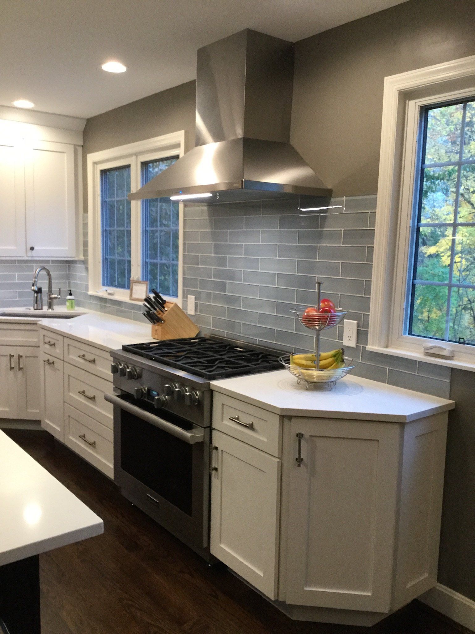 A kitchen with stainless steel appliances and white cabinets