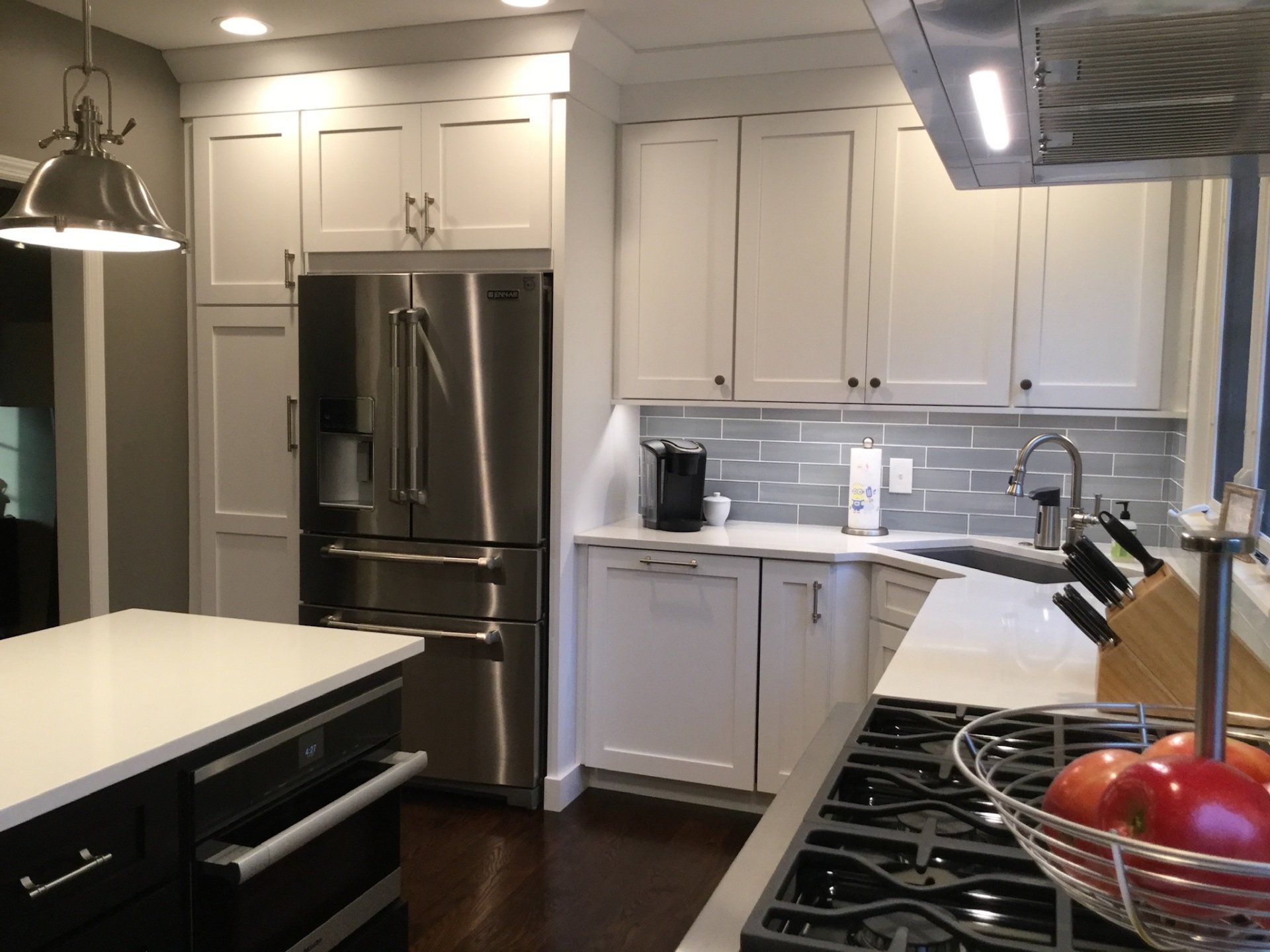 A kitchen with white cabinets and stainless steel appliances