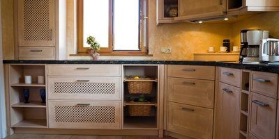A kitchen with wooden cabinets and a window.