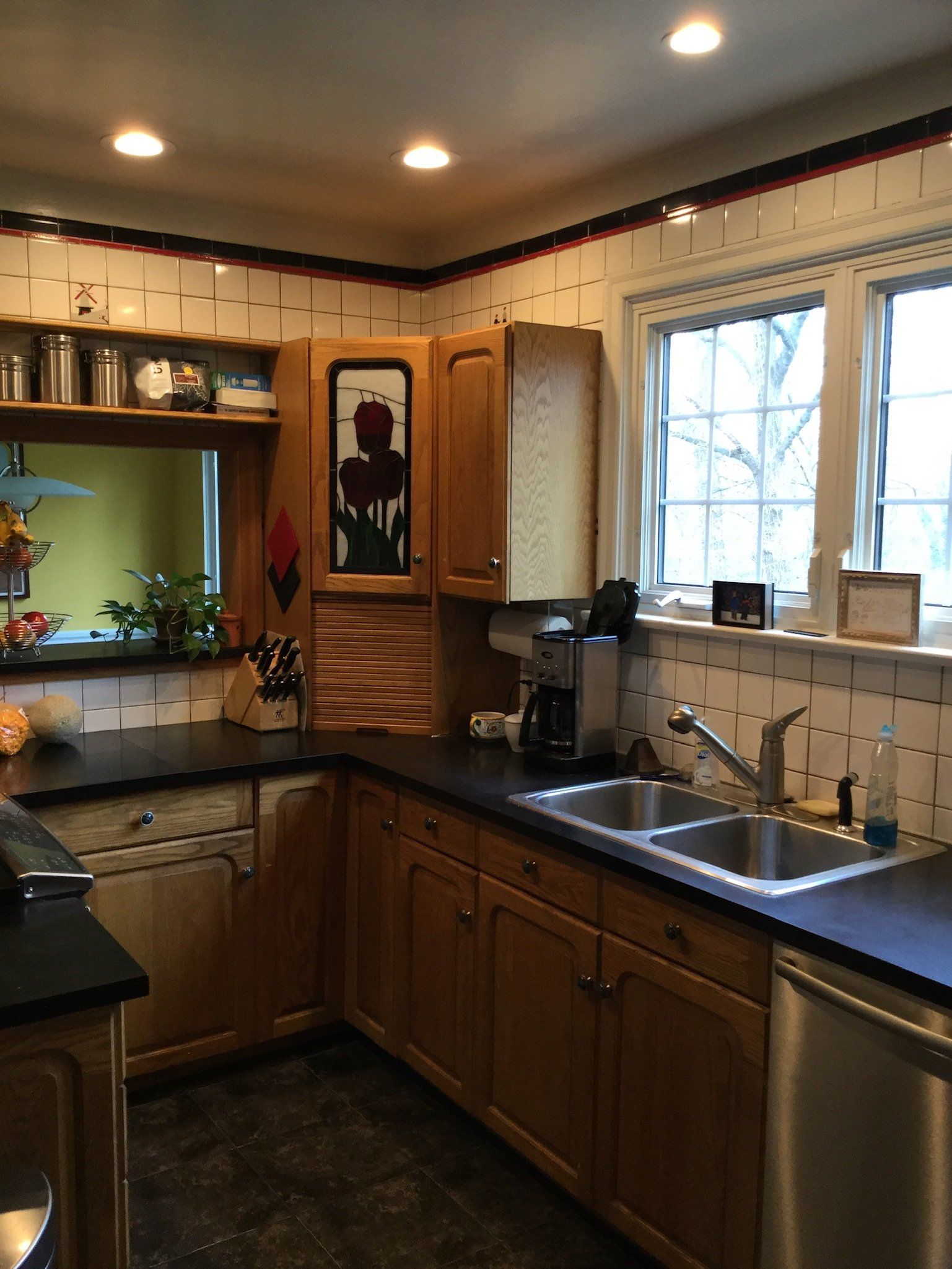 A kitchen with two sinks and a stainless steel dishwasher