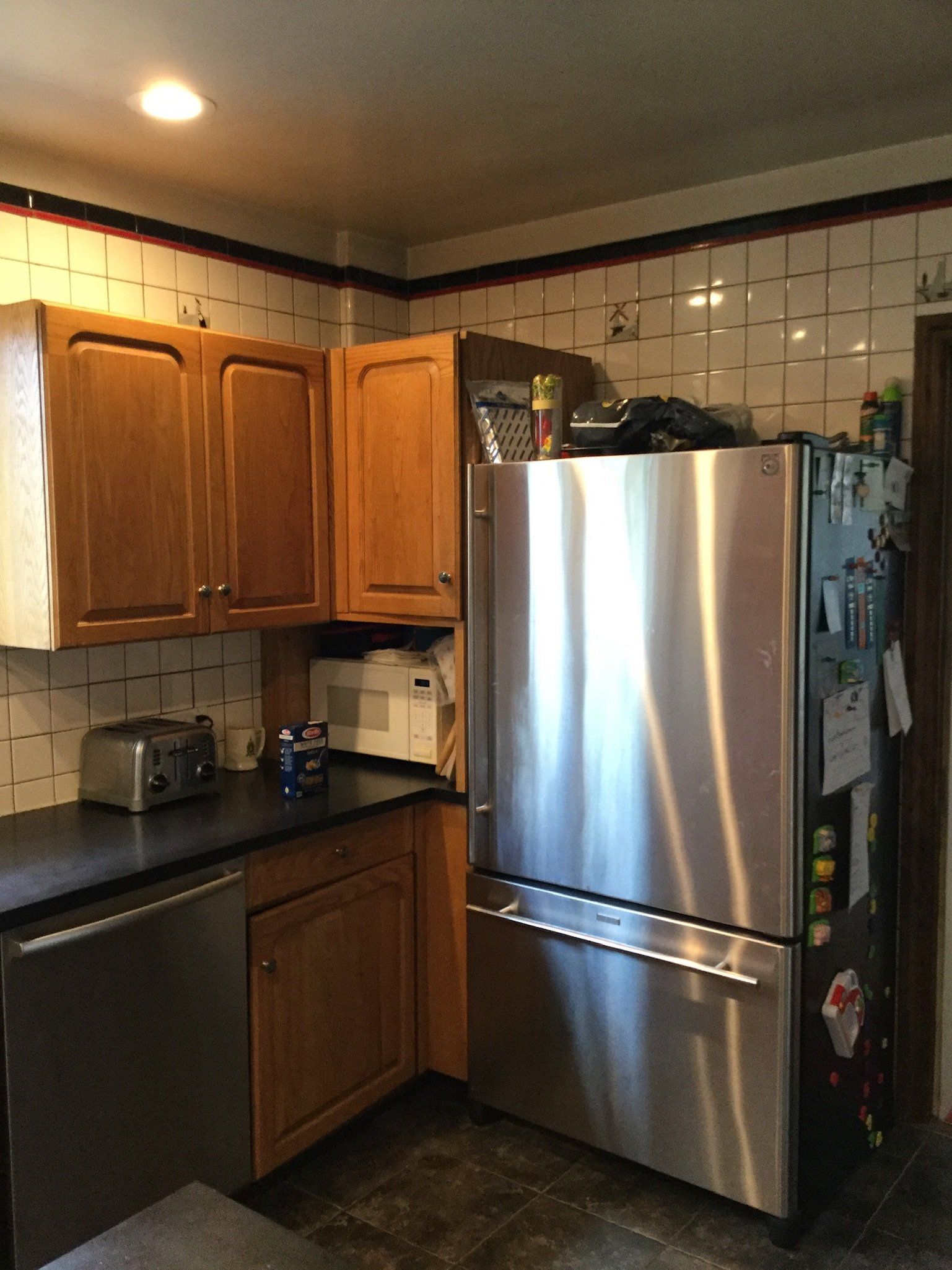 A kitchen with stainless steel appliances and wooden cabinets