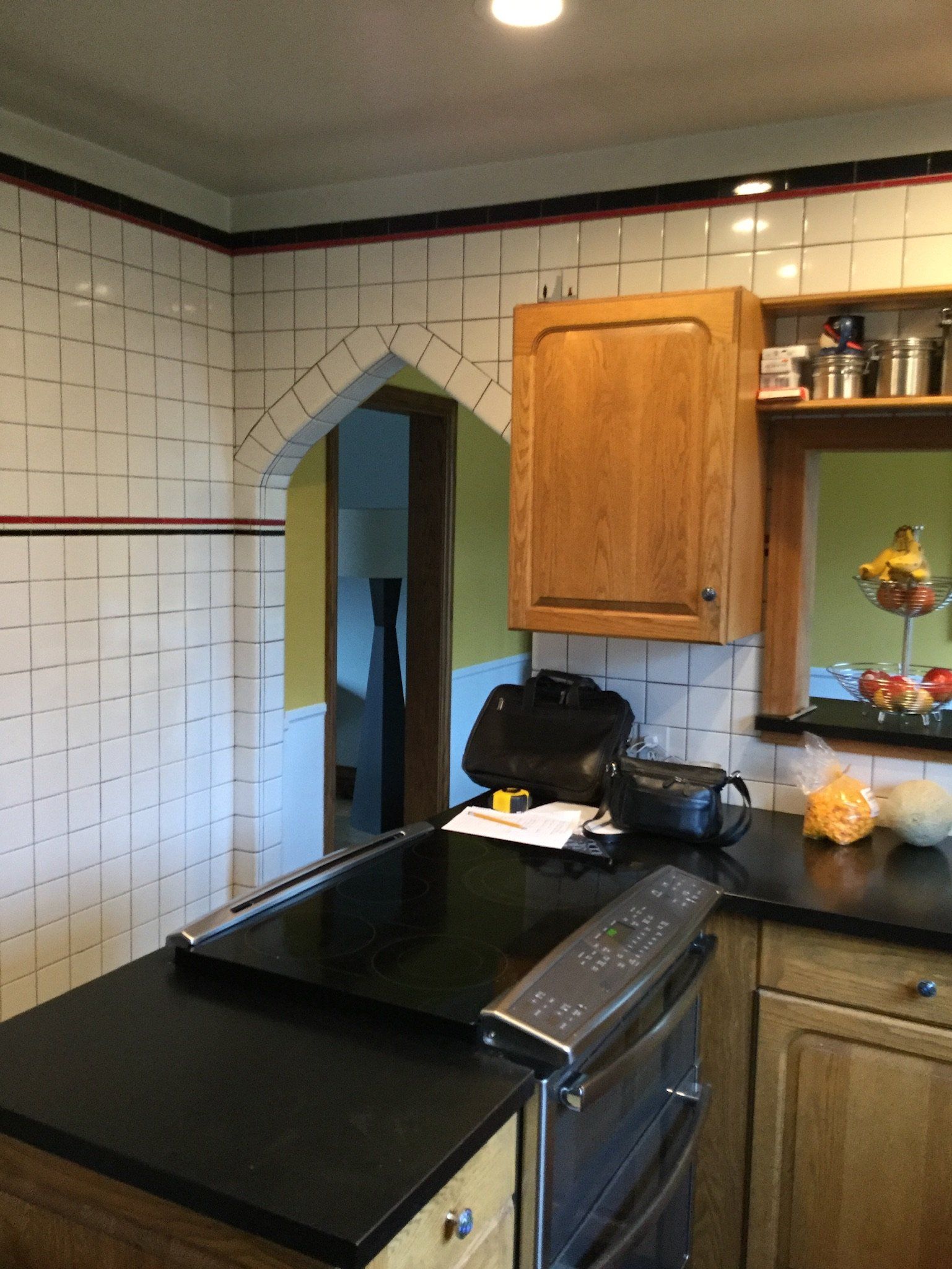 A kitchen with a stove top oven and wooden cabinets