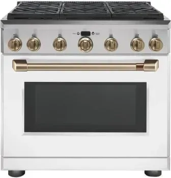 A white stove with gold knobs and a black door on a white background.