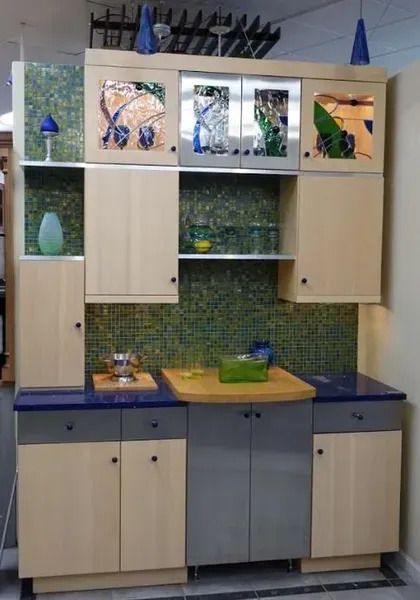 A kitchen with wooden cabinets and a blue counter top