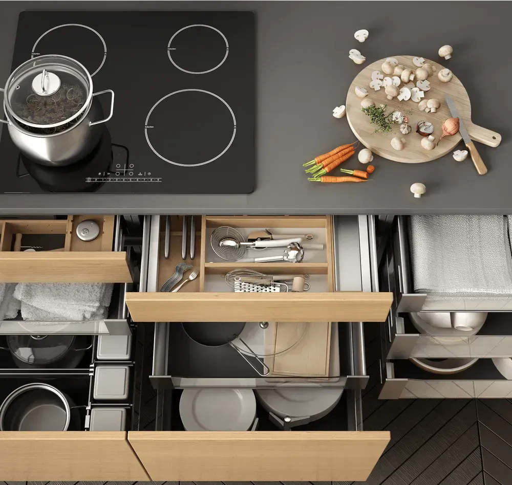 A kitchen counter with a pot and a cutting board with carrots on it