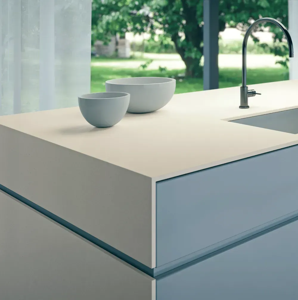 A kitchen counter with two bowls and a sink