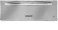 A stainless steel hood is hanging on a tiled wall.