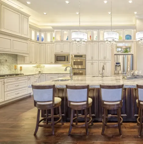 A kitchen with brown cabinets and white counter tops