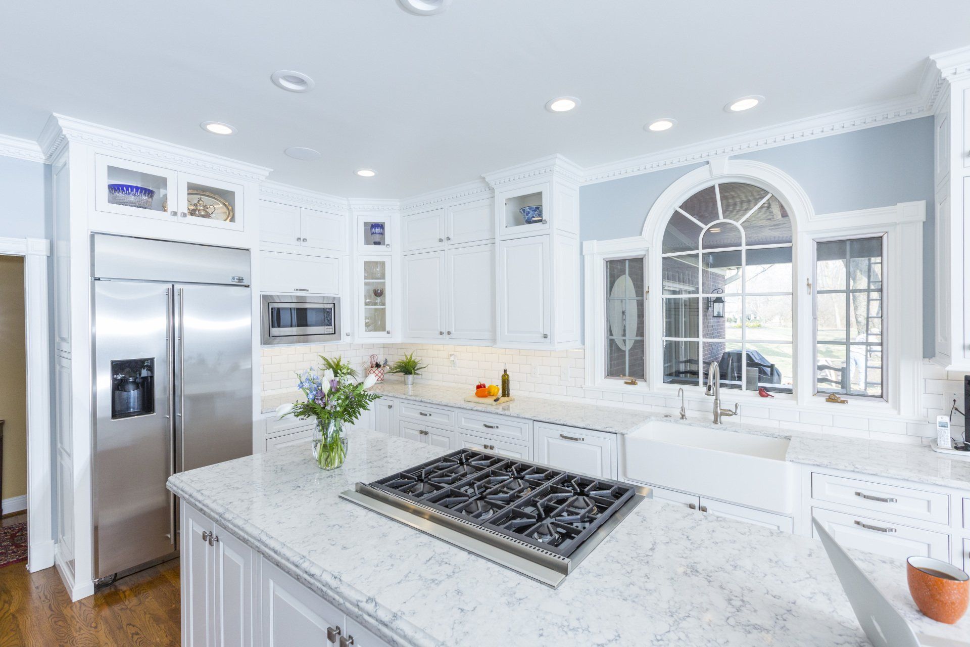 A kitchen with brown cabinets and white counter tops
