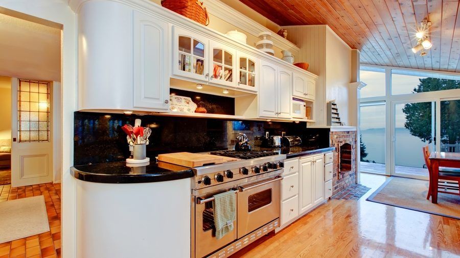 A kitchen with stainless steel appliances and white cabinets