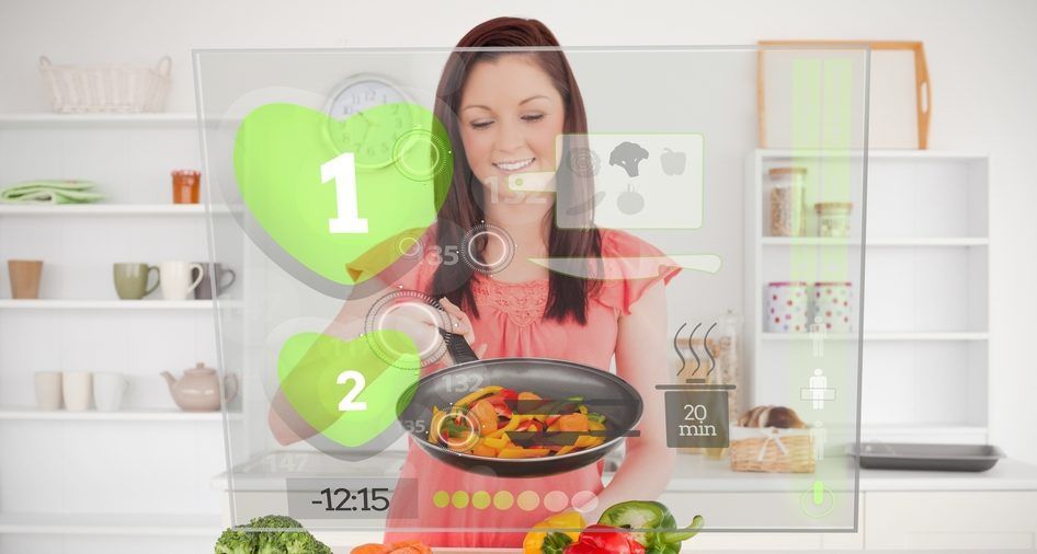 A woman is cooking in a kitchen with a virtual screen behind her.