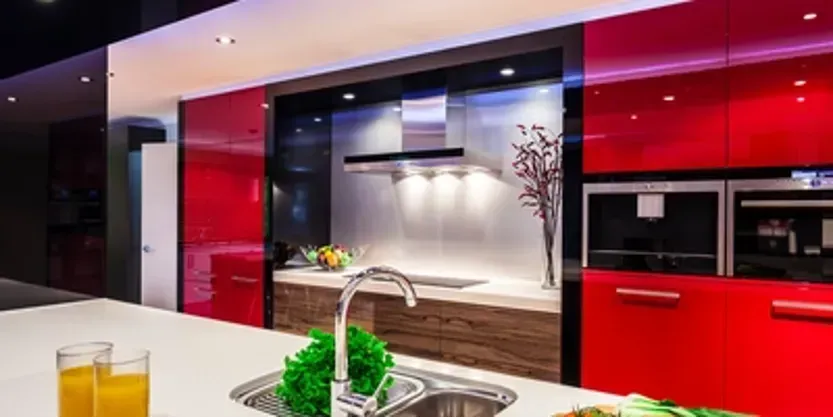 A kitchen with red cabinets and a sink.