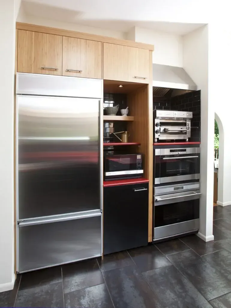 A kitchen with stainless steel appliances and wooden cabinets