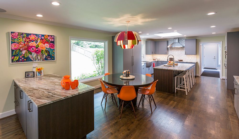 A kitchen and dining room in a house with a table and chairs.