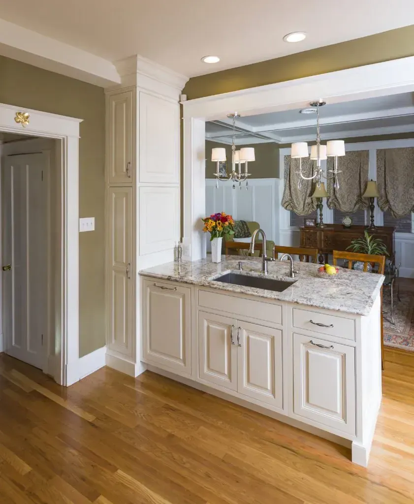 A kitchen with white cabinets and granite counter tops