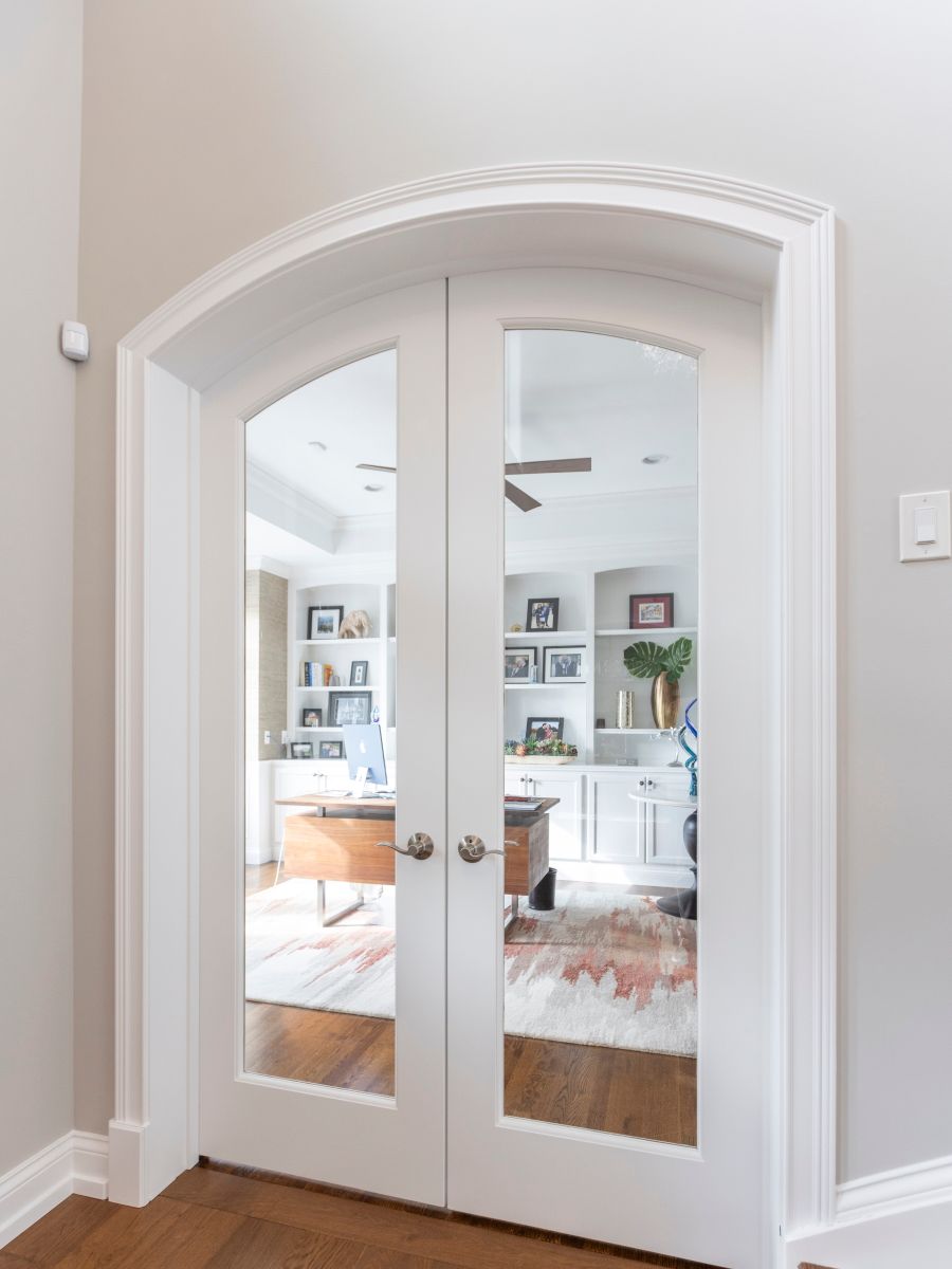 A pair of arched glass doors leading into a living room.