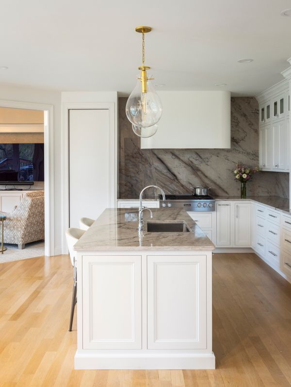 A kitchen with a large island and a sink