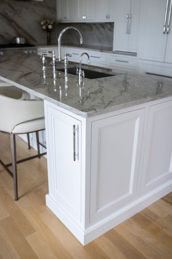 A kitchen with white cabinets and granite counter tops