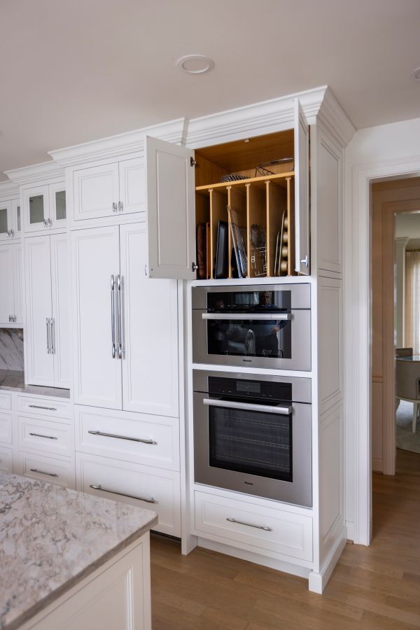 A kitchen with white cabinets and stainless steel appliances
