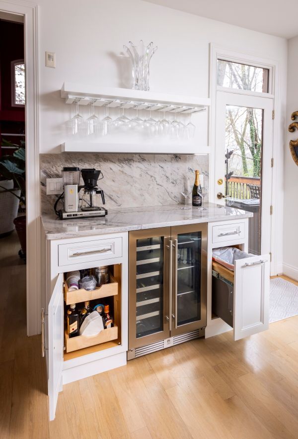 A kitchen with a wine cooler and a coffee maker.
