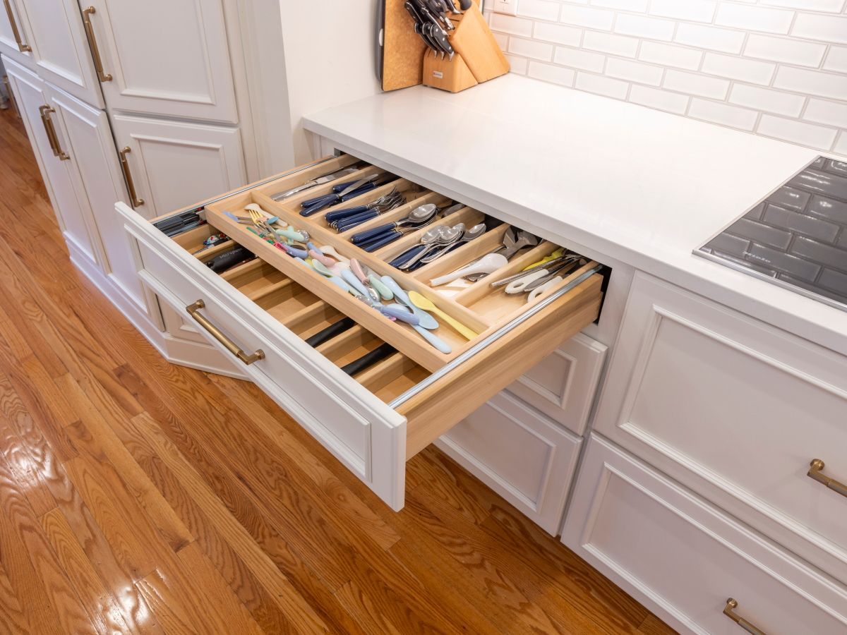 A kitchen drawer filled with utensils and knives.
