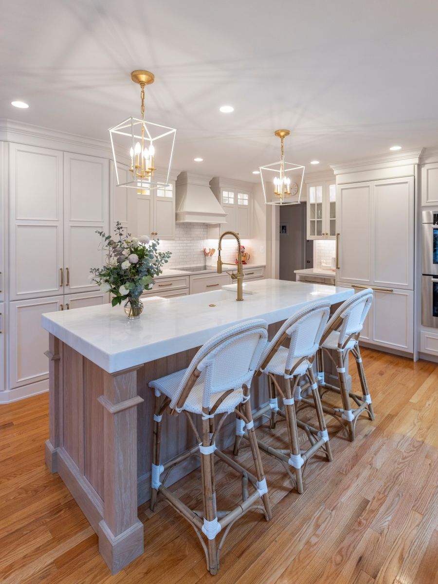 A kitchen with a large island and stools