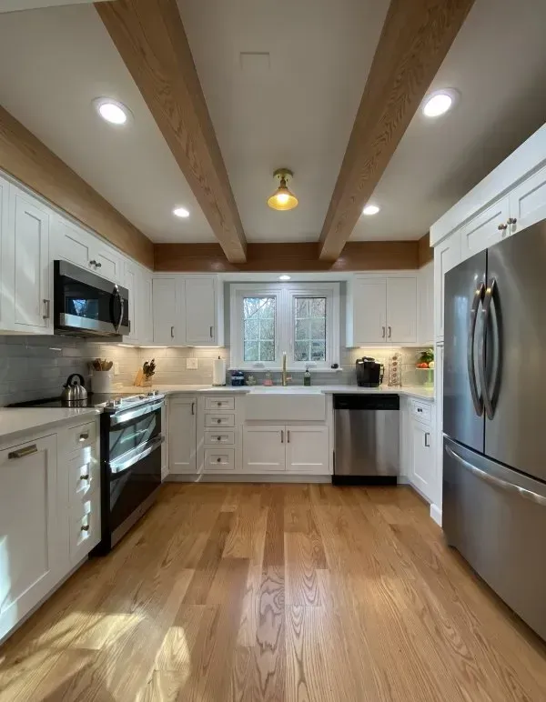 A kitchen with white cabinets and stainless steel appliances