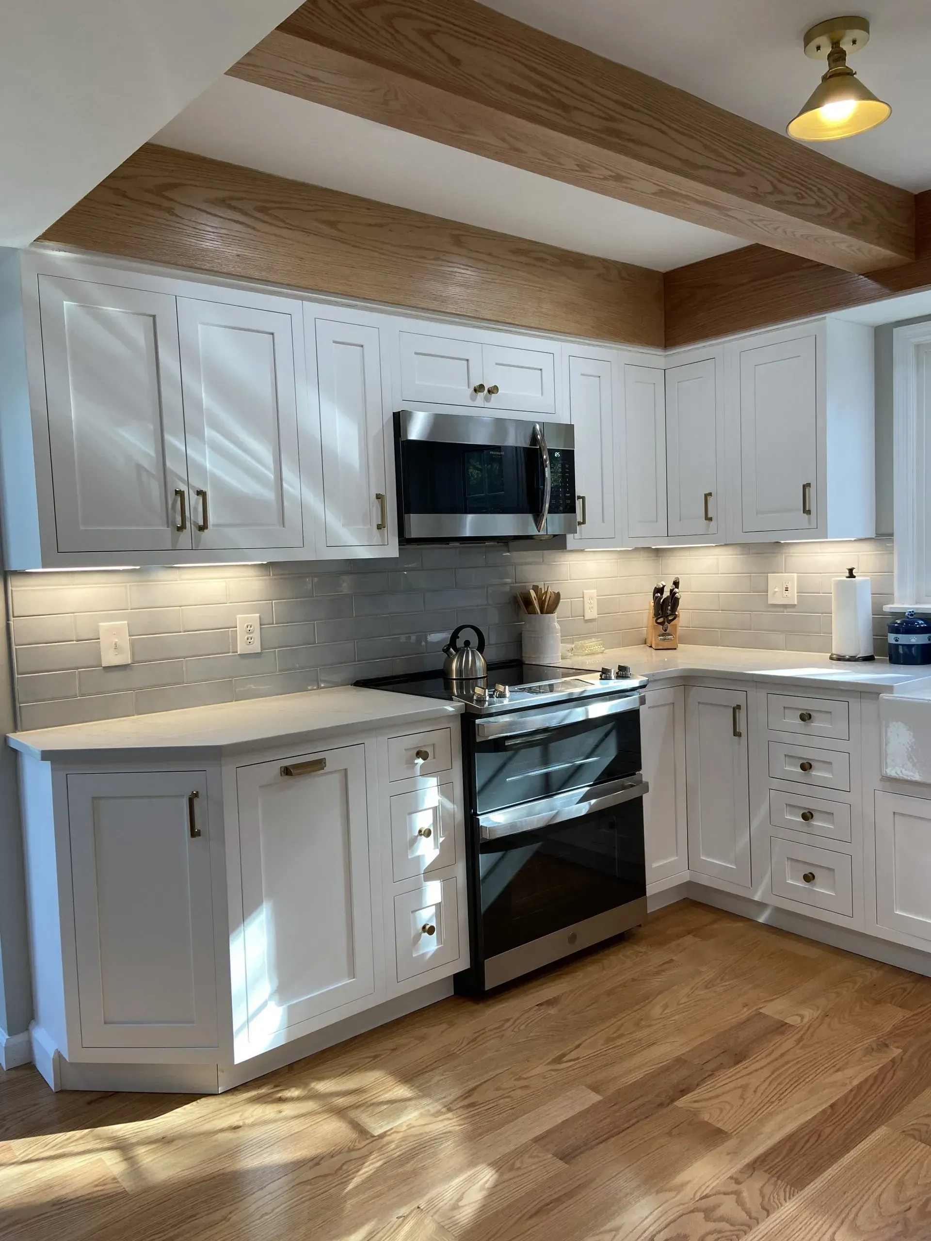 A kitchen with white cabinets and stainless steel appliances